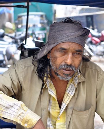 BANGALORE, IN - JULY 15: Rickshaw Driver waits for customers in Bangalore, IN July 15, 2010 in Bangalore, India. Typical mileage for an Indian-made auto rickshaw is around 35 kilometers per liter of petrolのeditorial素材