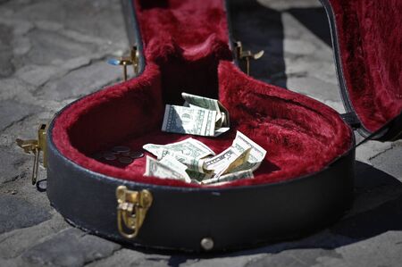 Sidewalk Guitar Case with Money Asking for Donations or Tipsの写真素材