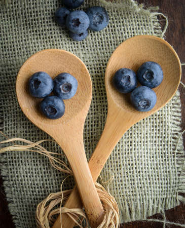 Blueberries on a Spoon with Burlap Woven Backgroundの写真素材