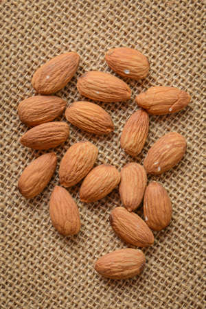 Almonds on Burlap Backgroundの写真素材