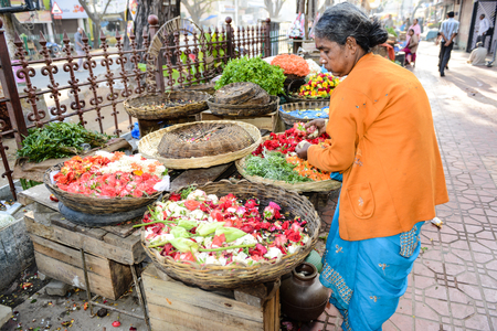 BANGALORE, IN - JANUARY 09: Vendor sells flowers on the street in Bangalore, IN January 09, 2013 in Bangalore, India. 42% of India falls below the international poverty line of $1.25 a day.のeditorial素材