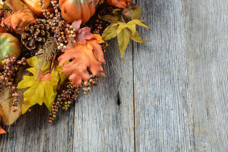 Autumn leaves and berry over wooden background for Thanksgivingの写真素材