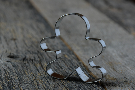 Gingerbread Cookie Cutter on Wood Backgroundの写真素材