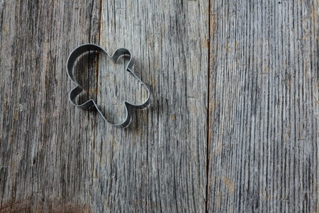 Gingerbread Man Cookie Cutter on Rustic Wood Backgroundの写真素材