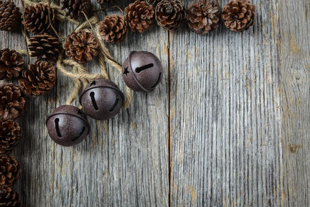 Pine cones and Rustic Bells on an Old Wood Backgroundの写真素材