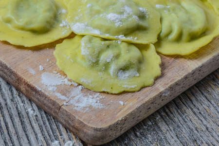 Spinach Ravioli on a Wood Cutting Boardの写真素材