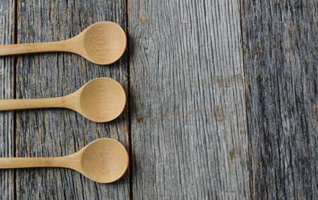 Wooden Cooking Spoons on a Rustic Wood Backgroundの写真素材