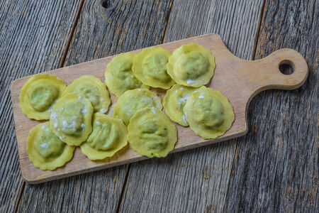 Spinach Ravioli on a Wood Cutting Boardの写真素材