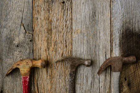 Old Hammers on Rustic Wood Backgroundの写真素材