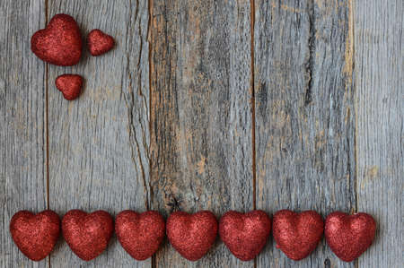 Valentine's Day Hearts on Rustic Wooden Backgroundの写真素材