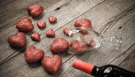 Wine Glass and Wine with Red Hearts on Valentine's Dayの写真素材