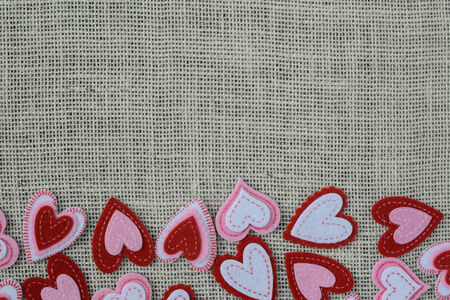 Red Hearts on Burlap Background