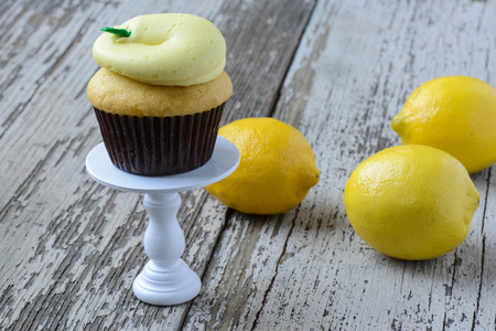 Lemon Cupcake with Fresh Lemons on a Cupcake Standの写真素材