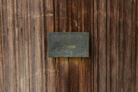 Old Wooden Door with Blank Metal Plateの写真素材