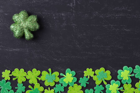 Green Clovers on Chalkboard Background Background for St. Patrick's Day Holidayの写真素材