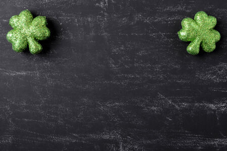 Green Clovers on Chalkboard Background Background for St. Patrick's Day Holidayの写真素材