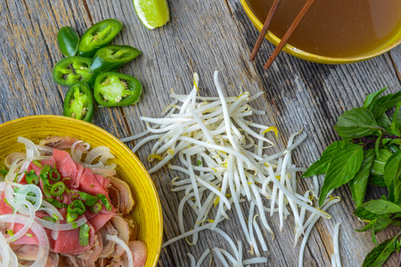 Pho Vietnamese beef soup on a wooden backgroundの写真素材