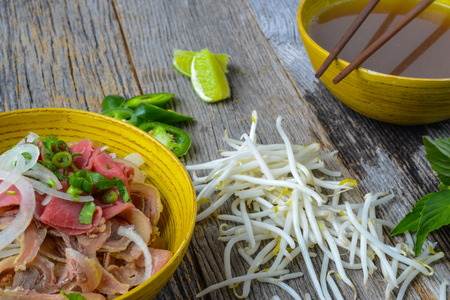 Pho Vietnamese beef soup on a wooden backgroundの写真素材