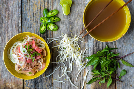 Pho Vietnamese beef soup on a wooden backgroundの写真素材