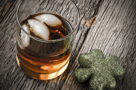 Glass of Whiskey and Clovers to celebrate St Patrick's Dayの写真素材
