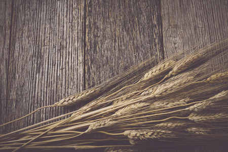 Close Up of Wheat on Rustic Wooden Tableの写真素材