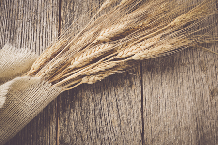 Wheat Ears over Rustic Wood and Burlap backgroundの写真素材