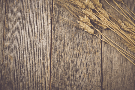 Close Up of Wheat on Rustic Wooden Tableの写真素材