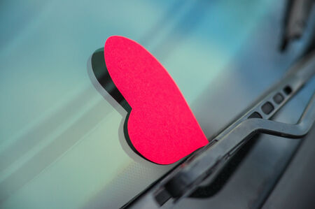Paper shaped heart on the car windowの写真素材