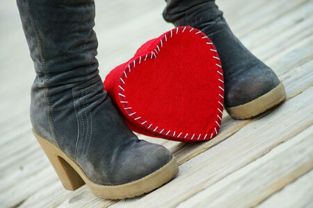 Heart on the road and woman`s bootsの写真素材