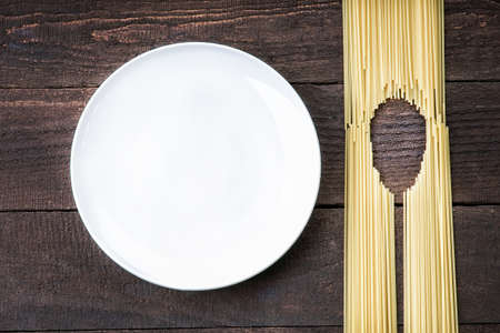 Spoon shape made of pasta and white dishの写真素材