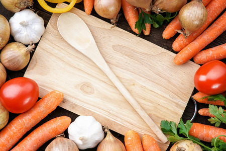 Healthy,fresh vegetables with wooden spoon and boardの写真素材
