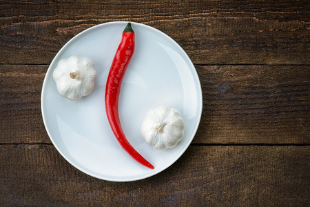 Plate with red hot chilli pepper and garlicの写真素材