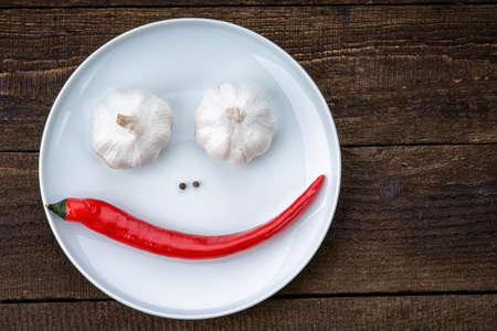Smiley face made from pepper, garlic and flavoringの写真素材