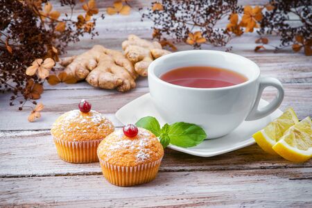 Cup of tea with muffins and gingerの写真素材