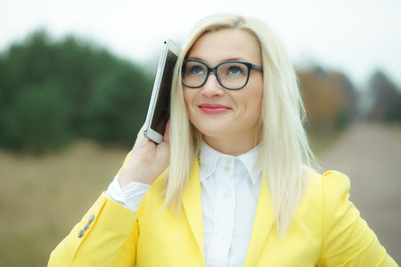 Pretty young woman with digital tabletの写真素材