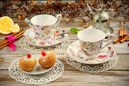 Vintage cups with muffins and cookiesの写真素材