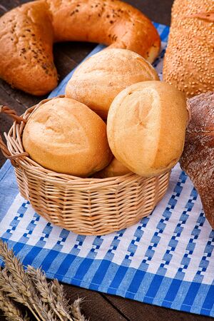Wicker basket with buns on the tableclothの写真素材