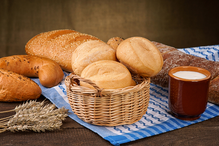Bread products with milk cup on the tableclothの写真素材