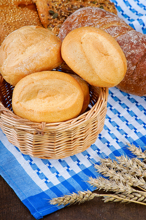Basket with buns on the tableclothの写真素材
