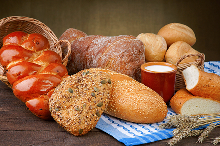 Assortment of baked bread with milk cupの写真素材