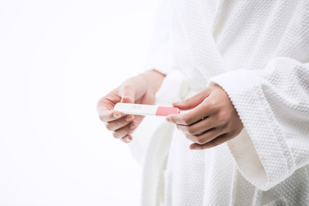 Asian Woman with Pregnancy Testの写真素材