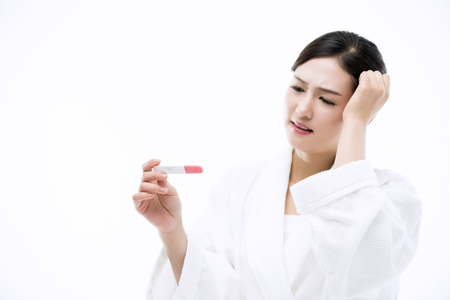 Asian Woman with Pregnancy Testの写真素材