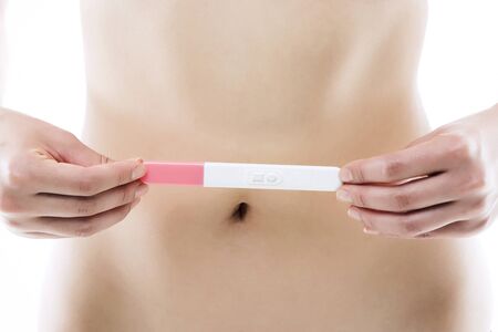 Asian Woman with Pregnancy Testの写真素材