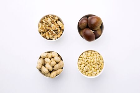Different Types of Nuts in Bowls, Isolated on Whiteの写真素材