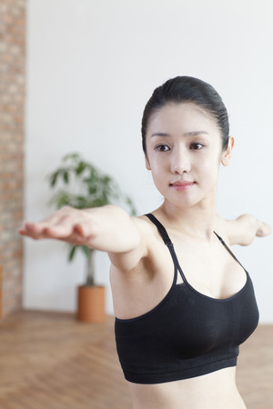 Performing yoga aloneの写真素材