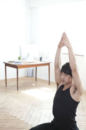 Performing yoga aloneの写真素材
