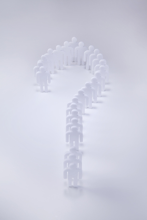 Miniature people cutouts making a question markの写真素材