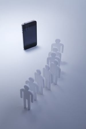 Miniature people cutouts making a lineの写真素材