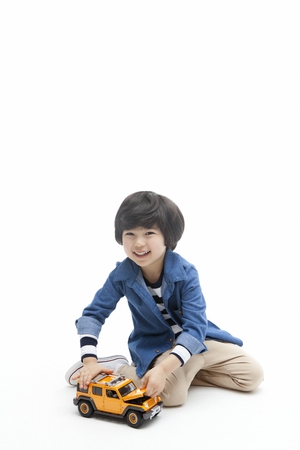 A child in blue shirt playing aloneの写真素材