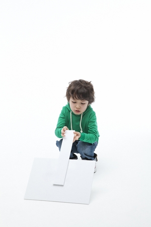 A child in green playing aloneの写真素材